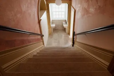 a staircase in a building with a window at Estefânia Luxury Apartment Historic House Downtown in Porto