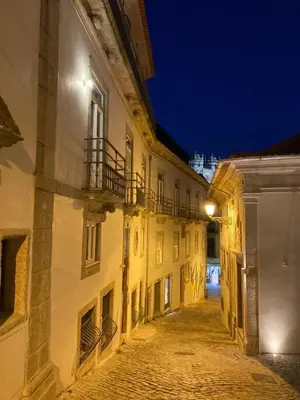 an empty alley in an old building at night at Estefânia Luxury Apartment Historic House Downtown in Porto