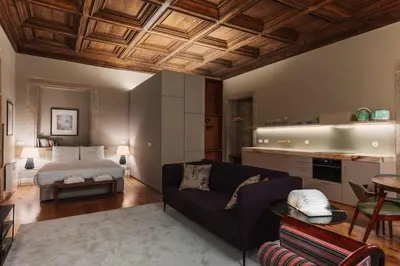 a living room with a couch and a bed at Estefânia Luxury Apartment Historic House Downtown in Porto