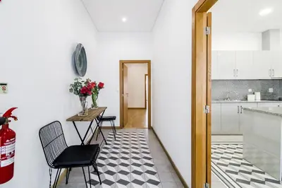 a kitchen with a table and chairs in a room at Asgard Oporto Downtown Apartments in Porto