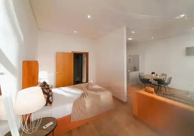 a bedroom with a bed and a couch and a table at Asgard Oporto Downtown Apartments in Porto
