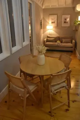 a living room with a table and chairs and a couch at The Nest in Porto