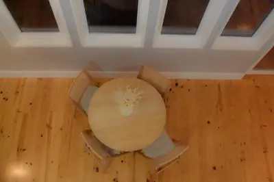 a round table in a room with a wooden floor at The Nest in Porto