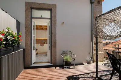 a house with a wooden deck with a glass door at Maria Pia Luxury Apartment, Historic House Downtow in Porto