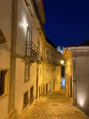 an empty alley in an old building at night at Maria Pia Luxury Apartment, Historic House Downtow in Porto