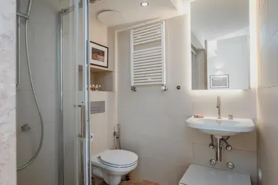 a bathroom with a toilet and a sink and a shower at Maria Pia Luxury Apartment, Historic House Downtow in Porto