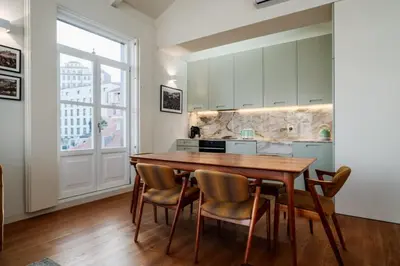 a kitchen with a wooden table and chairs at Victoria Luxury Apartment, Historic House Downtown in Porto