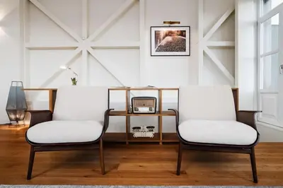 two chairs in a room with a table and a clock at Victoria Luxury Apartment, Historic House Downtown in Porto
