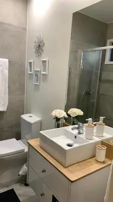 a bathroom with a white sink and a toilet at Ilha D’ouro House S. Vitor in Porto