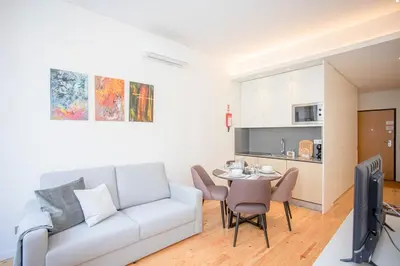 a living room with a white couch and a table at Liiiving in Porto-Mouzinho Residence Apartments in Porto