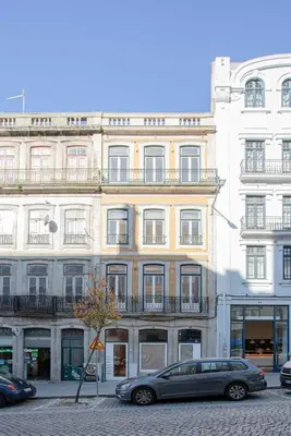 a car parked in front of a large building at Liiiving in Porto-Mouzinho Residence Apartments in Porto