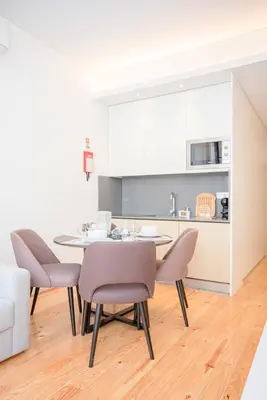 a kitchen and dining room with a table and chairs at Liiiving in Porto-Mouzinho Residence Apartments in Porto