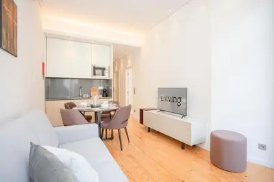a living room with a white couch and a table at Liiiving in Porto-Mouzinho Residence Apartments in Porto