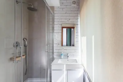 a white bathroom with a sink and a shower at GuestReady - Portfolio GuestHouse in Porto