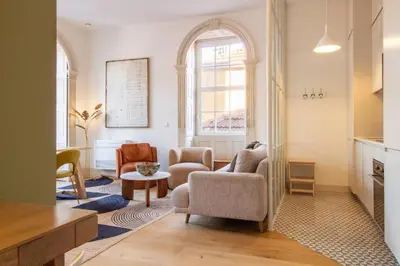 a living room with two chairs and a table at Casa Azul Santa Marinha in Vila Nova de Gaia