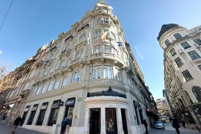 a large white building with people walking in front of it at Dream On - Aliados Delux 2 Bed in Porto