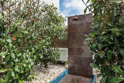 a garden with trees and a brick wall at InLapa Studio III in Porto