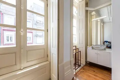 a bathroom with a sink and a window at InLapa Studio III in Porto
