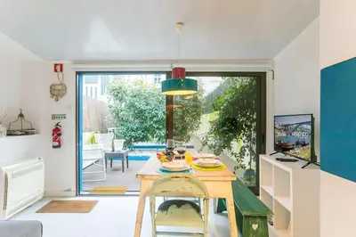 a kitchen with a table and a dining room at Porto InLapa Studio VI Garden in Porto