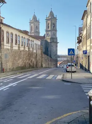 an empty street with a building and a clock tower at Porto InLapa Studio VI Garden in Porto