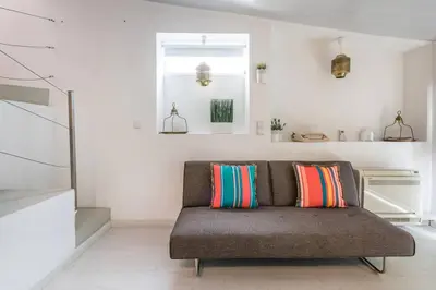 a couch with colorful pillows in a living room at Porto InLapa Studio VI Garden in Porto