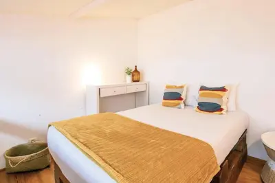 a bedroom with a bed with pillows on it at Porto InLapa Studio VI Garden in Porto
