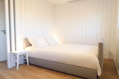 a bedroom with a white bed and a side table at Terrace Douro in Vila Nova de Gaia