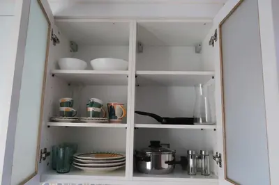 a white cabinet with dishes and utensils in it at Terrace Douro in Vila Nova de Gaia