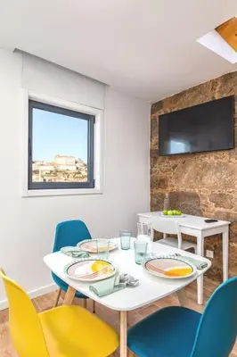 a dining room with a white table and chairs at Terrace Douro in Vila Nova de Gaia