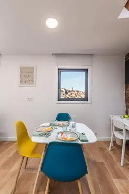 a dining room with a white table and chairs at Terrace Douro in Vila Nova de Gaia