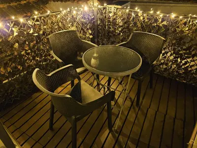 a group of chairs and a table on a deck with lights at Terrace Douro in Vila Nova de Gaia