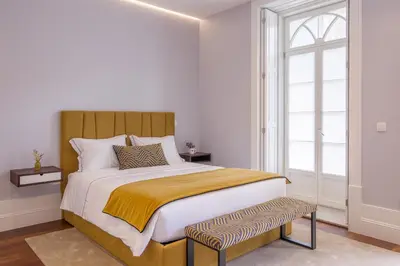 a bedroom with a large bed and a window at Porto Almada 180 Apartments in Porto