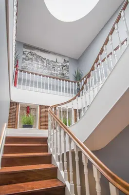 a staircase with white railings and wood treads at Porto Almada 180 Apartments in Porto