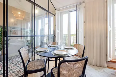 a dining room with a table and chairs at Bonfim Elegant Duplex w/ AC by LovelyStay in Porto