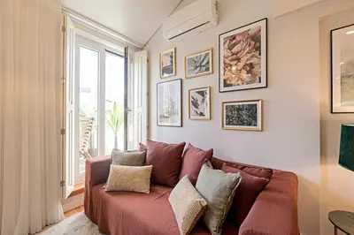 a living room with a couch and a window at Bonfim Elegant Duplex w/ AC by LovelyStay in Porto