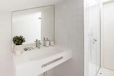 a white bathroom with a sink and a mirror at Bonfim Elegant Duplex w/ AC by LovelyStay in Porto