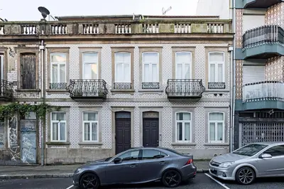 two cars parked in front of a building at Bonfim Elegant Duplex w/ AC by LovelyStay in Porto