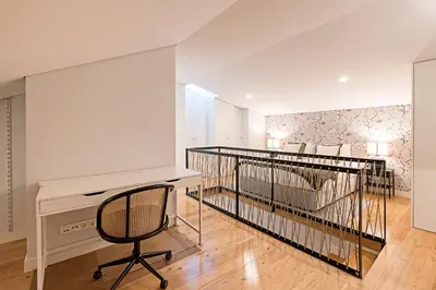 a bedroom with a bed and a desk and a chair at Bonfim Elegant Duplex w/ AC by LovelyStay in Porto