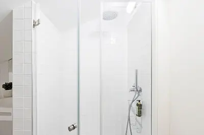 a shower with a glass door in a bathroom at Bonfim Elegant Duplex w/ AC by LovelyStay in Porto