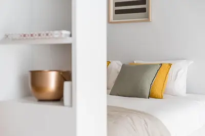a bedroom with a bed with white sheets and pillows at GuestReady - Studio Five-0-Five in Porto