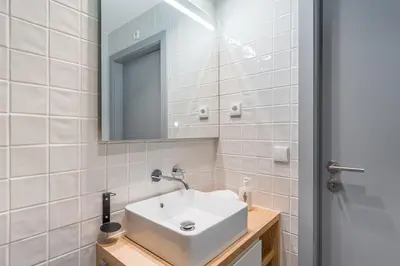 a bathroom with a white sink and a mirror at GuestReady - Studio Five-0-Five in Porto