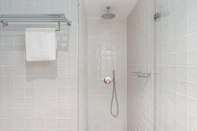 a bathroom with a shower with a shower head at GuestReady - Studio Five-0-Five in Porto