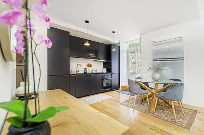 a kitchen and dining room with a table and chairs at Monte dos Judeus I by Innkeeper in Porto