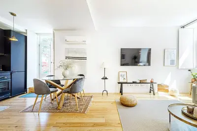 a living room with a table and chairs at Monte dos Judeus I by Innkeeper in Porto