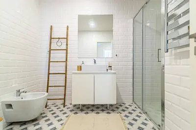a bathroom with a sink and a toilet and a mirror at Monte dos Judeus I by Innkeeper in Porto