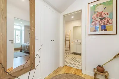 a hallway with a mirror and a bedroom at Monte dos Judeus I by Innkeeper in Porto