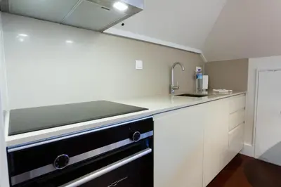 a kitchen with a sink and a counter top at Trindade - Loft apartment in Porto