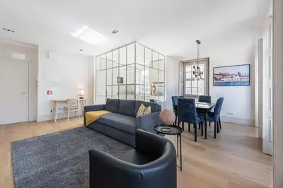 a living room with a couch and a table at GuestReady - Porto Wine District Penthouse in Vila Nova de Gaia