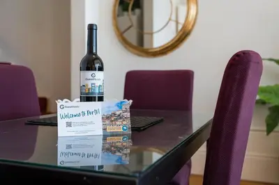 a bottle of wine sitting on top of a table at GuestReady - Bright Apartment near Bolhão in Porto