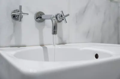 a sink with water running from a faucet at GuestReady - Bright Apartment near Bolhão in Porto